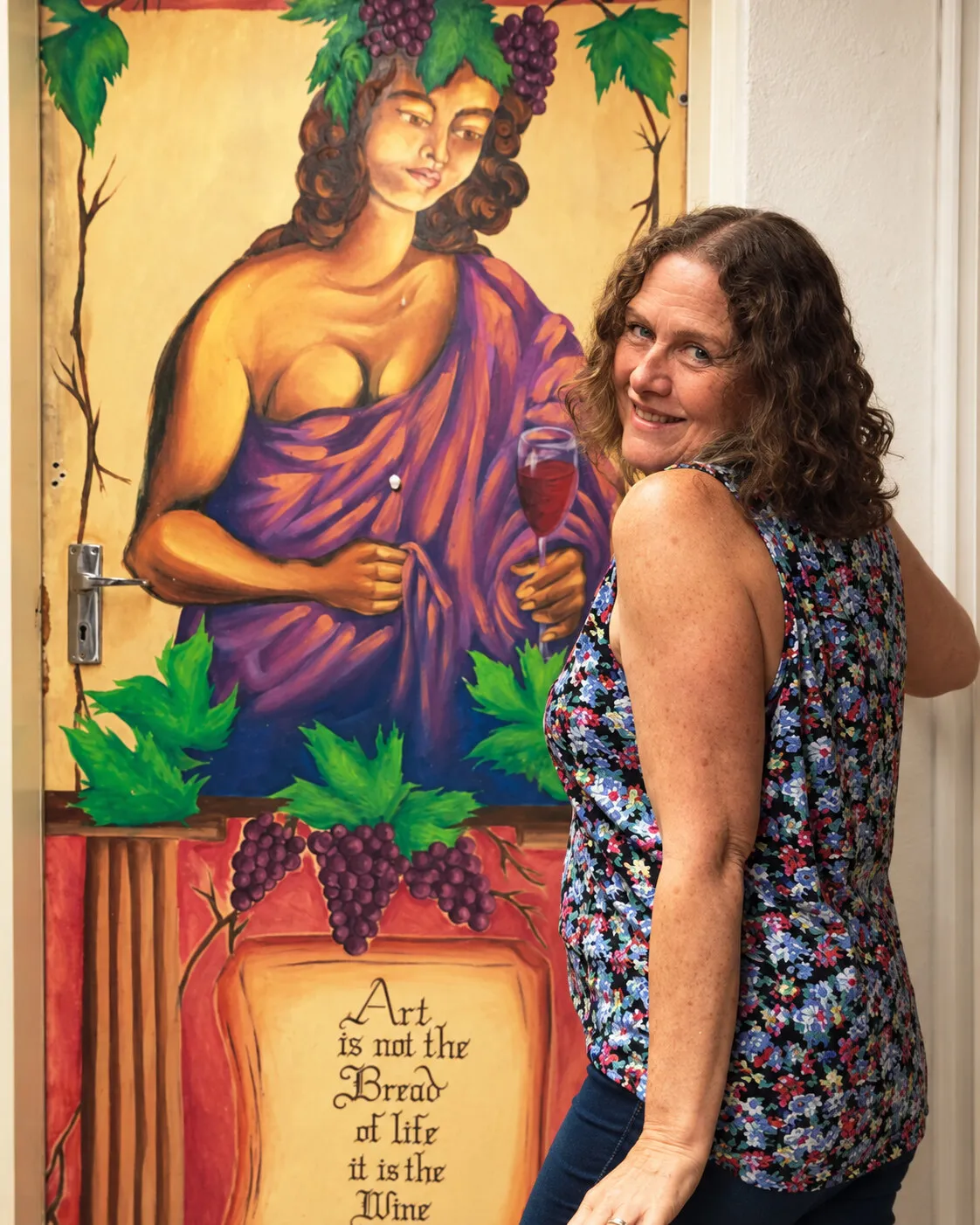 Visitor beside a painted artwork at MelonRouge